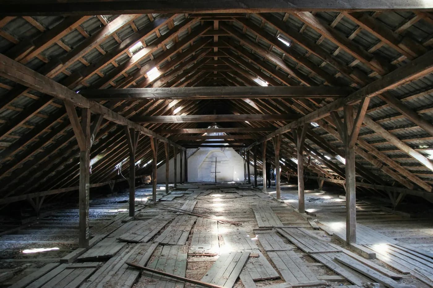 The exposed rafters and roof boards of an unfinished attic