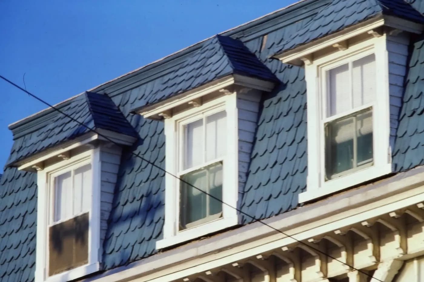 Dormers set into the slate-patterned mansard roof of Fryer's Cottage in Cape May, New Jersey