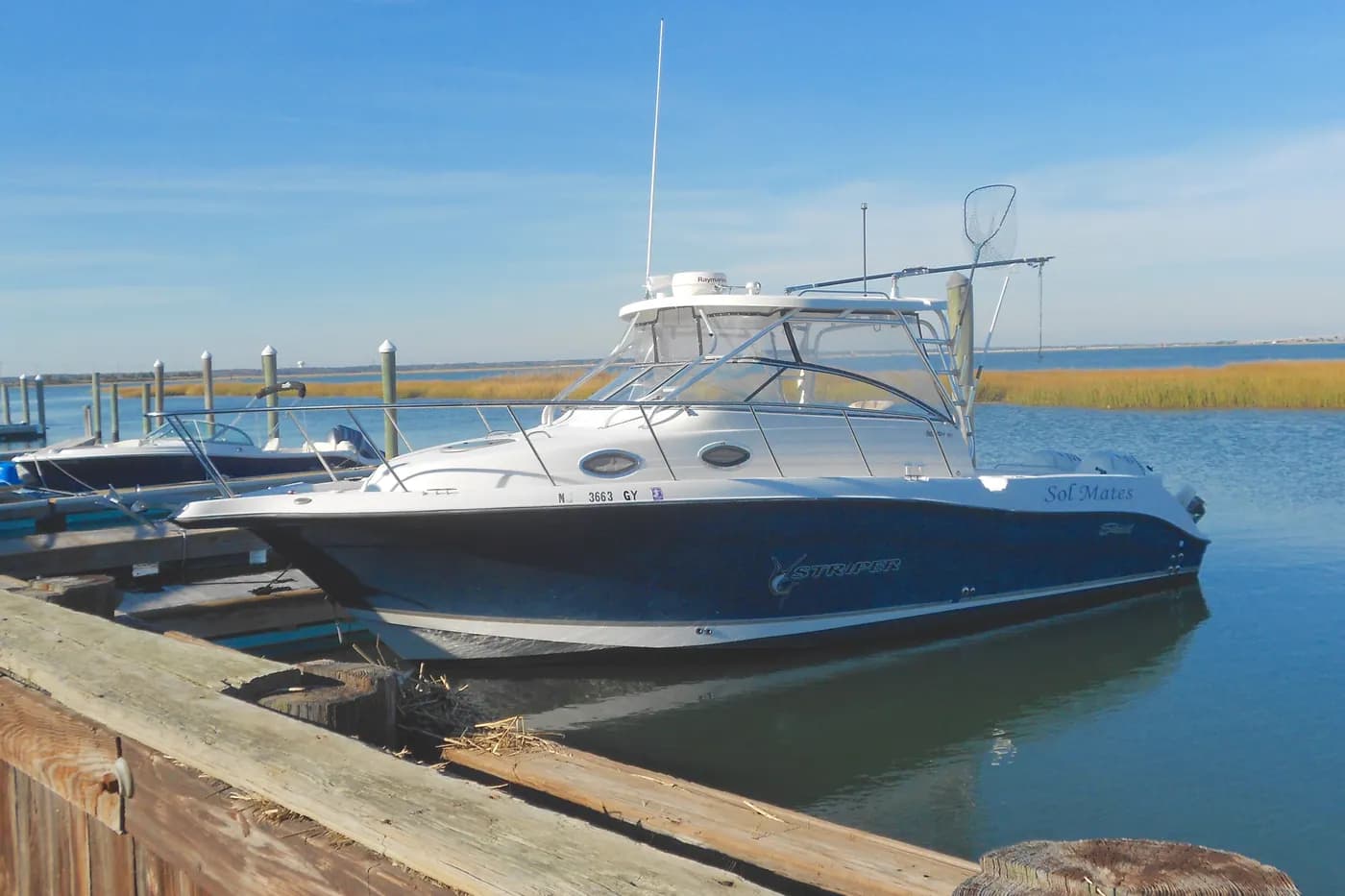 A boat moored on the back bay beside the marsh in West Wildwood, New Jersey