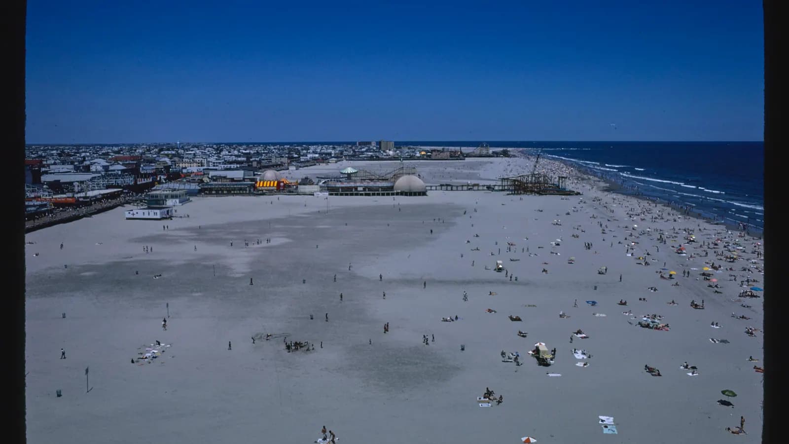 An elevated view looking north over the wide beach and boardwalk at Wildwood, New Jersey
