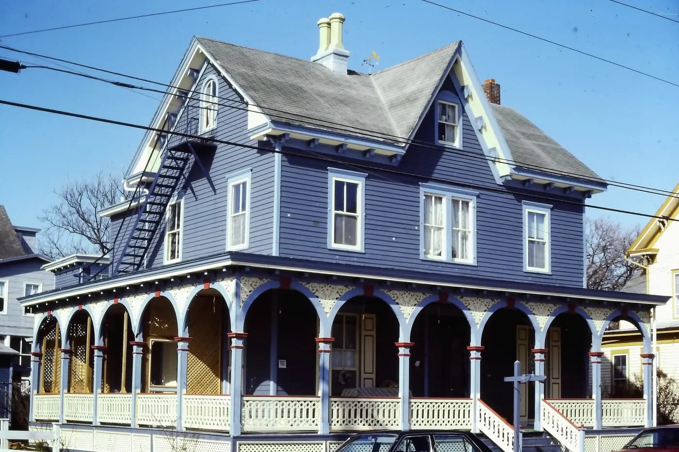 The 1872–73 John Tack House in Cape May, New Jersey, with steep cross gables, decorative trim and a wraparound porch