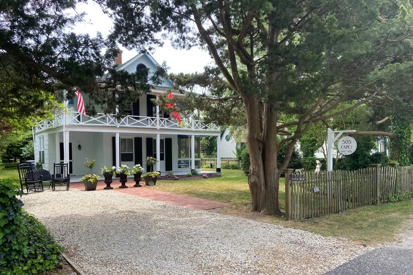 A two-storey house with a porch set among trees in Cape May Point, New Jersey